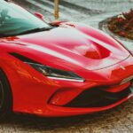 Luxury Cars - Stunning red Ferrari sports car parked on a cobb #11884897