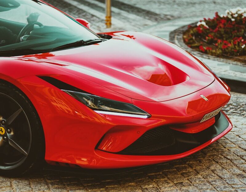 Luxury Cars - Stunning red Ferrari sports car parked on a cobb #11884897