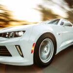 Luxury Cars - A white sportscar in motion showcasing speed and #1213294