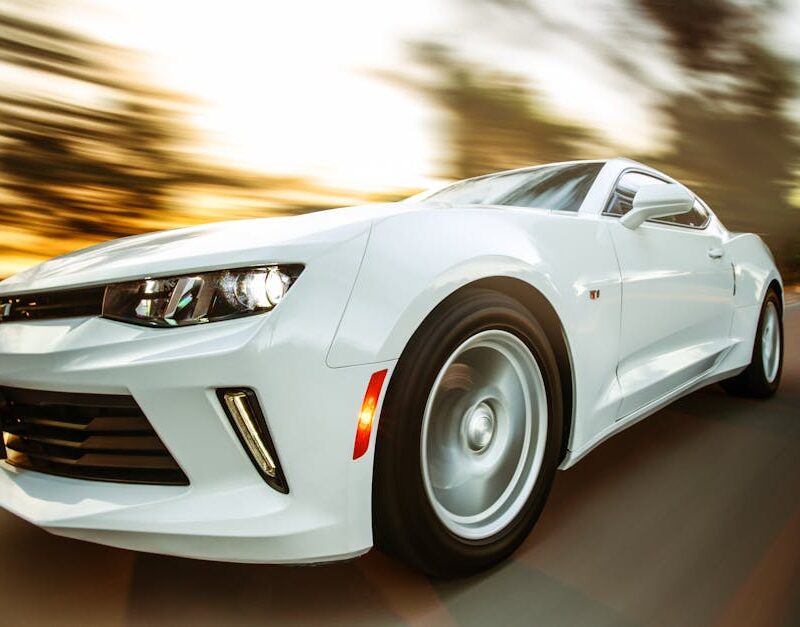 Luxury Cars - A white sportscar in motion showcasing speed and #1213294