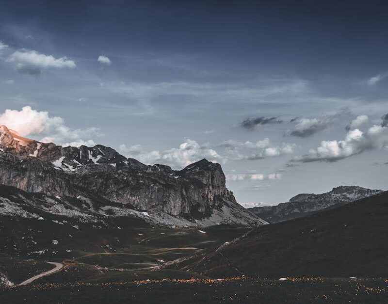 Mountain Landscapes - Dramatic mountain landscape under a cloudy sky i #12265989