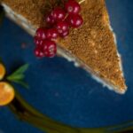 Food Aesthetics - Tantalizing slice of cake topped with red berrie #1639566