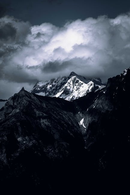Mountain Landscapes - Moody mountain landscape with snow-capped peaks #17077984