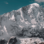Mountain Landscapes - Stunning snowcapped mountain peak under a clear #18375238