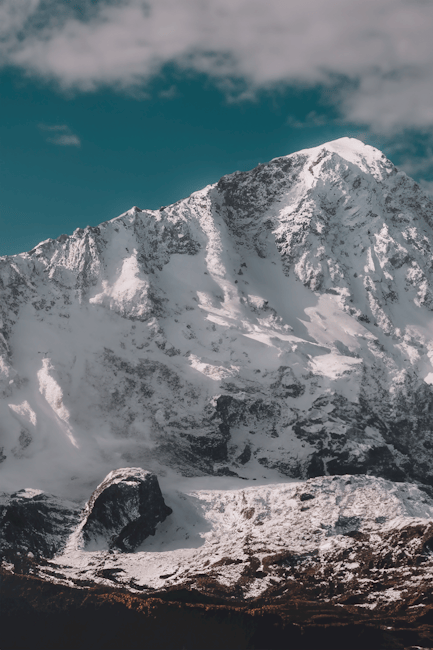 Mountain Landscapes - Stunning snowcapped mountain peak under a clear #18375238