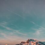 Mountain Landscapes - Stunning snow-capped mountain landscape under a #1850030