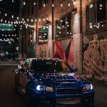 Luxury Cars - Blue Nissan Skyline R34 GTR in urban alley with #19163276
