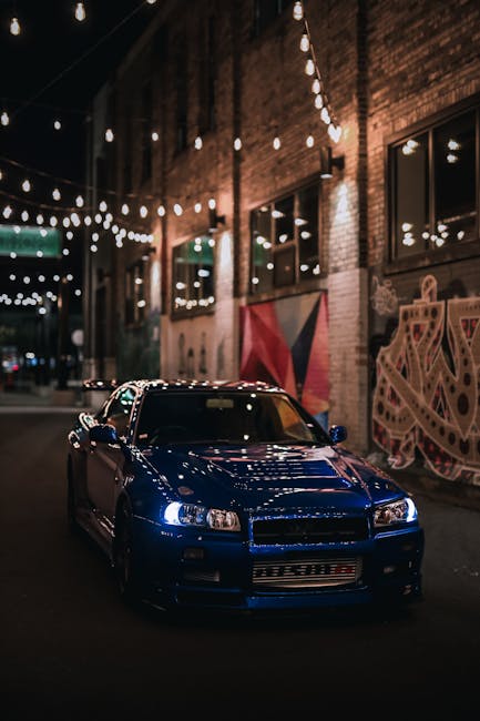 Luxury Cars - Blue Nissan Skyline R34 GTR in urban alley with #19163276