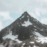 Mountain Landscapes - Stunning view of a rugged, snow-dotted mountain #27240701