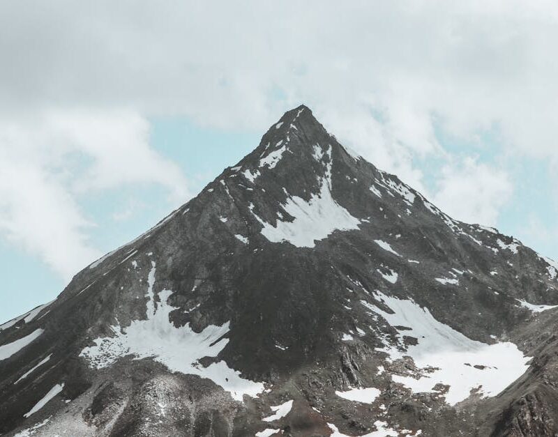 Mountain Landscapes - Stunning view of a rugged, snow-dotted mountain #27240701