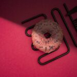 Food Aesthetics - Delicious pink frosted donut with colorful sprin #28860881