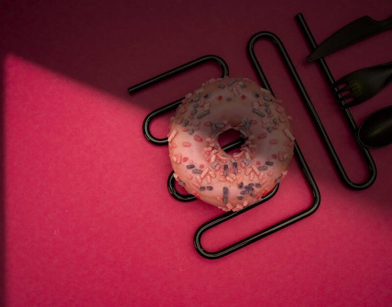 Food Aesthetics - Delicious pink frosted donut with colorful sprin #28860881