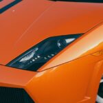 Luxury Cars - Vibrant orange sports car front view showcasing #29884351