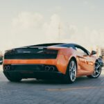 Luxury Cars - Rear view of an orange Lamborghini parked outdoo #29884357