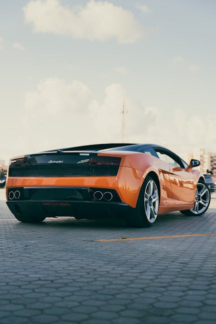 Luxury Cars - Rear view of an orange Lamborghini parked outdoo #29884357