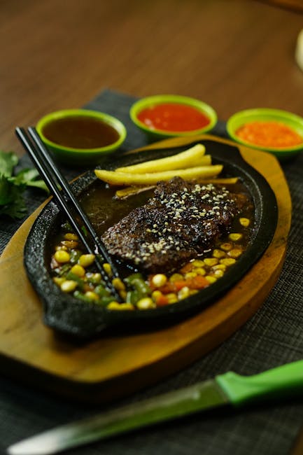 Food Aesthetics - Sizzling steak served with fries and three flavo #29899522
