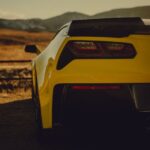 Luxury Cars - Rear view of a yellow sports car parked in a sce #30981568