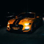 Luxury Cars - A striking orange sports car with black stripes #31968469