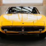 Luxury Cars - A classic yellow sports car showcased indoors, h #32725735