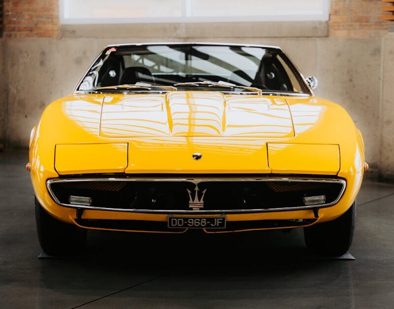 Luxury Cars - A classic yellow sports car showcased indoors, h #32725735