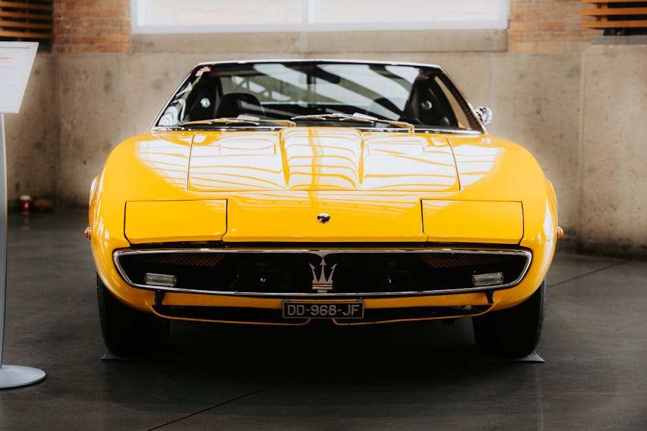 Luxury Cars - A classic yellow sports car showcased indoors, h #32725735
