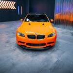 Luxury Cars - Bright orange sports car showcased indoors with #32729912
