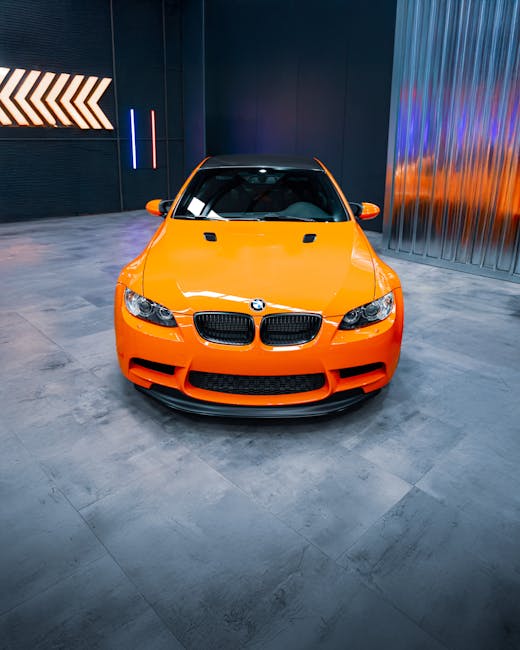 Luxury Cars - Bright orange sports car showcased indoors with #32729912