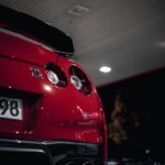 Luxury Cars - Dramatic night shot of a red Nissan GT-R at a ga #34277061