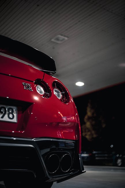 Luxury Cars - Dramatic night shot of a red Nissan GT-R at a ga #34277061