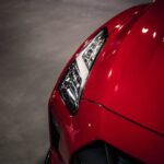 Luxury Cars - Close-up shot of a red Nissan GTR headlight in a #34277065