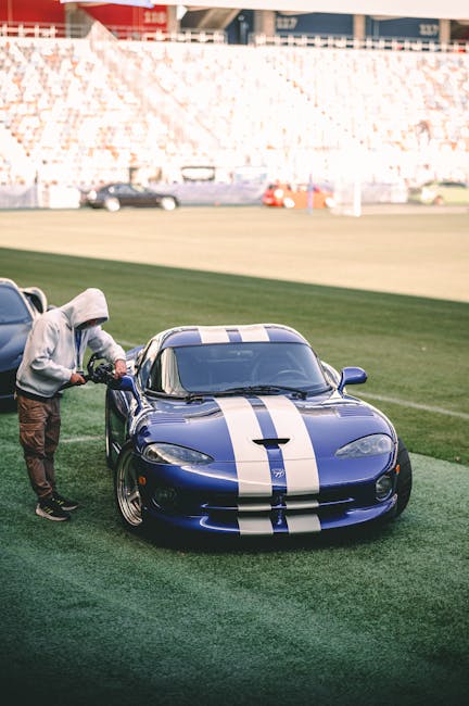 Luxury Cars - Blue sports car with racing stripes showcased ou #34444968