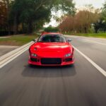 Luxury Cars - Dynamic front view of red sports car driving on #34911543