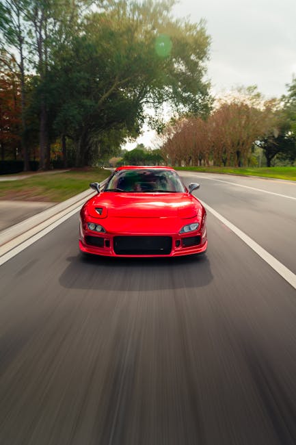 Luxury Cars - Dynamic front view of red sports car driving on #34911543