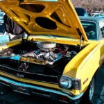 Luxury Cars - Vibrant yellow vintage muscle car with hood open #35528207