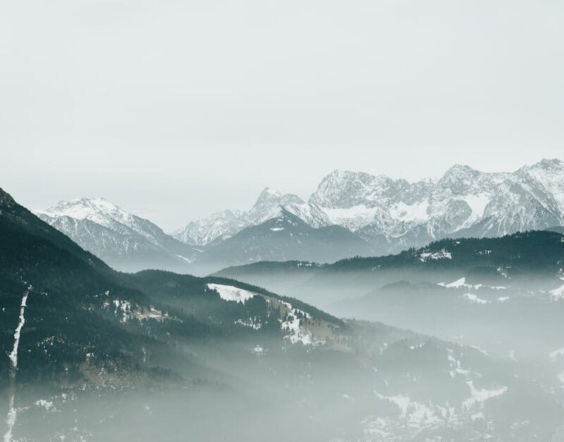 Mountain Landscapes - Serene view of a misty, snow-covered alpine moun #35898951