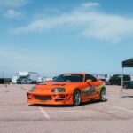 Luxury Cars - Vivid orange Toyota Supra displayed at an outdoo #36417232