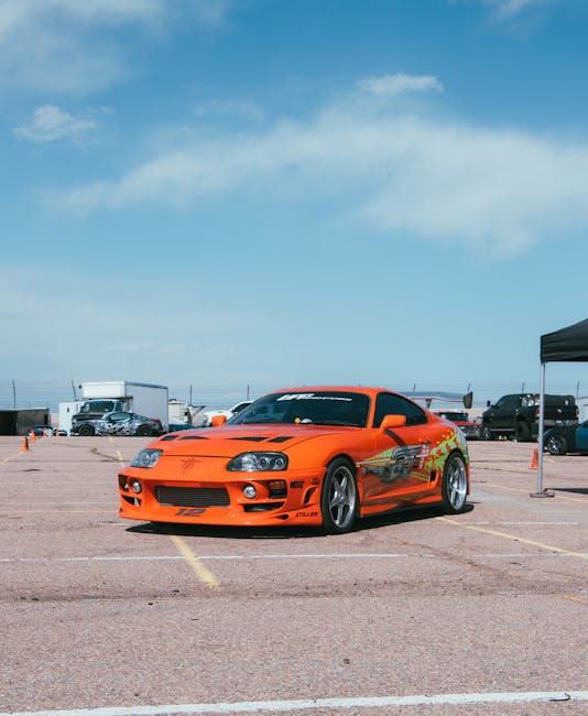 Luxury Cars - Vivid orange Toyota Supra displayed at an outdoo #36417232