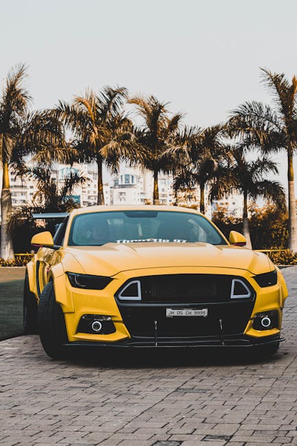 Luxury Cars - Vibrant yellow sports car parked outdoors agains #6867272