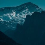 Mountain Landscapes - High steep mountain range covered with white sno #7179493